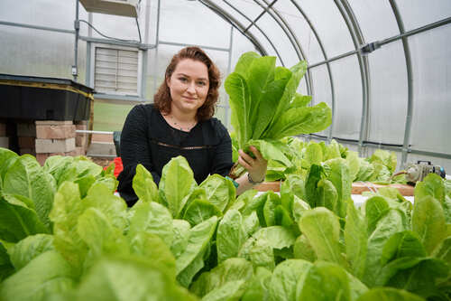 Student in a greenhouse